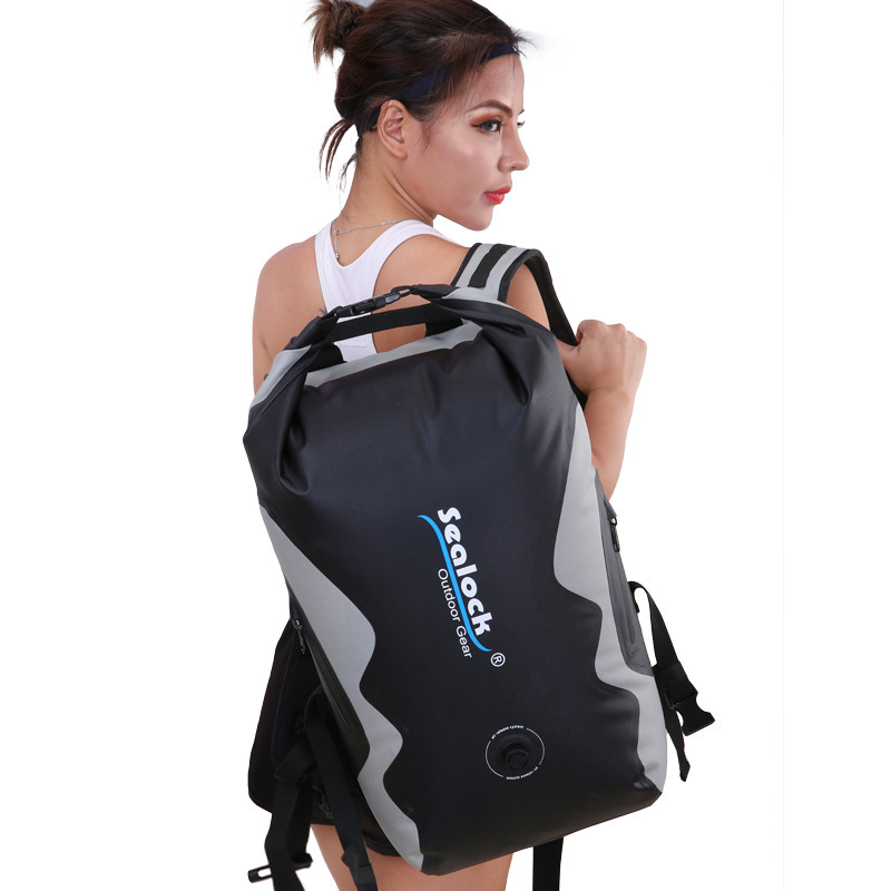 IPX8 waterproof roll top dry backpack with air valve on a kayak
